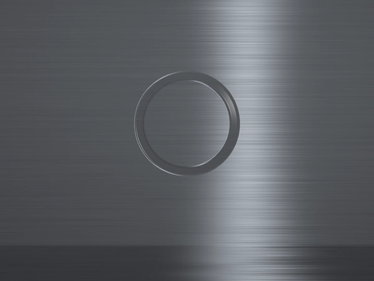 Close-up of brushed aluminium with a soft highlight and the Hollow ring engraved.